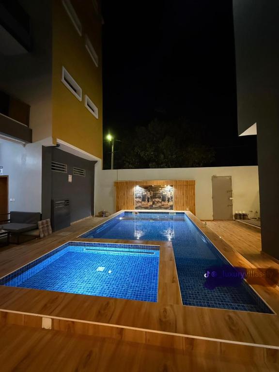 a swimming pool at night in a house at Studio moderne in Saly Portudal