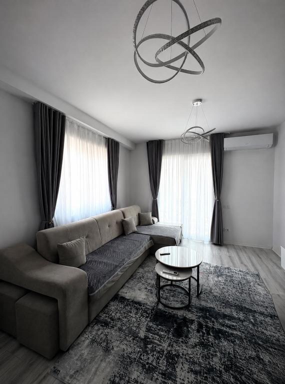 a living room with a couch and a table at Best House Albania in Kamëz