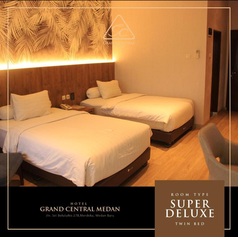 two beds in a hotel room with at Grand Central Medan in Medan