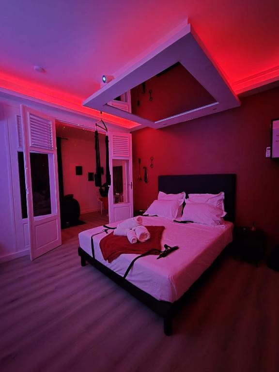 a bedroom with a large bed with a red light at Love Room Owfeah in Pointe-à-Pitre