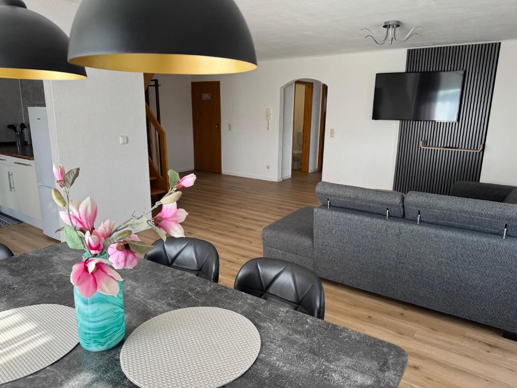 a living room with a table and a couch at Casa Blanca in Schwanau