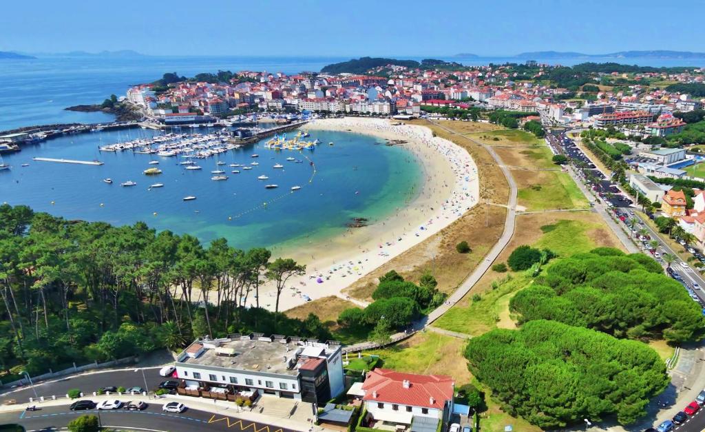 an aerial view of a harbor with boats in the water at GALIHOST - Casa Chouba, frente a la playa in Sanxenxo