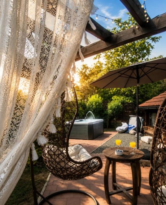 a patio with two chairs and a table with an umbrella at Breg&Spa in Beretinec