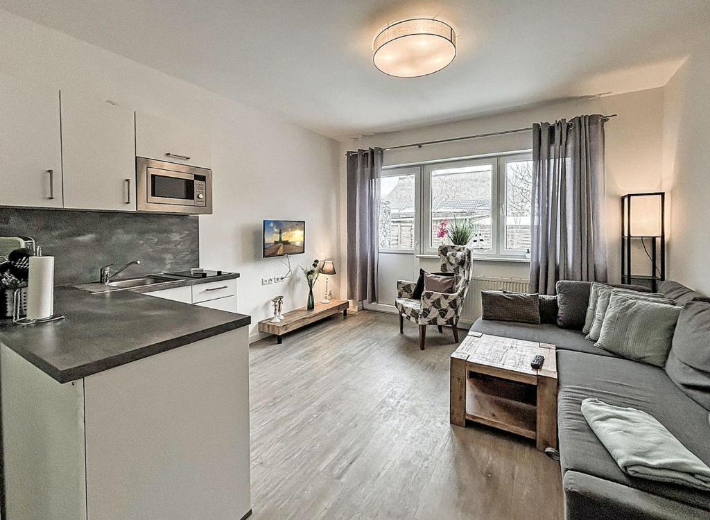 a kitchen and living room with a couch and a table at Bugoase in Dranske