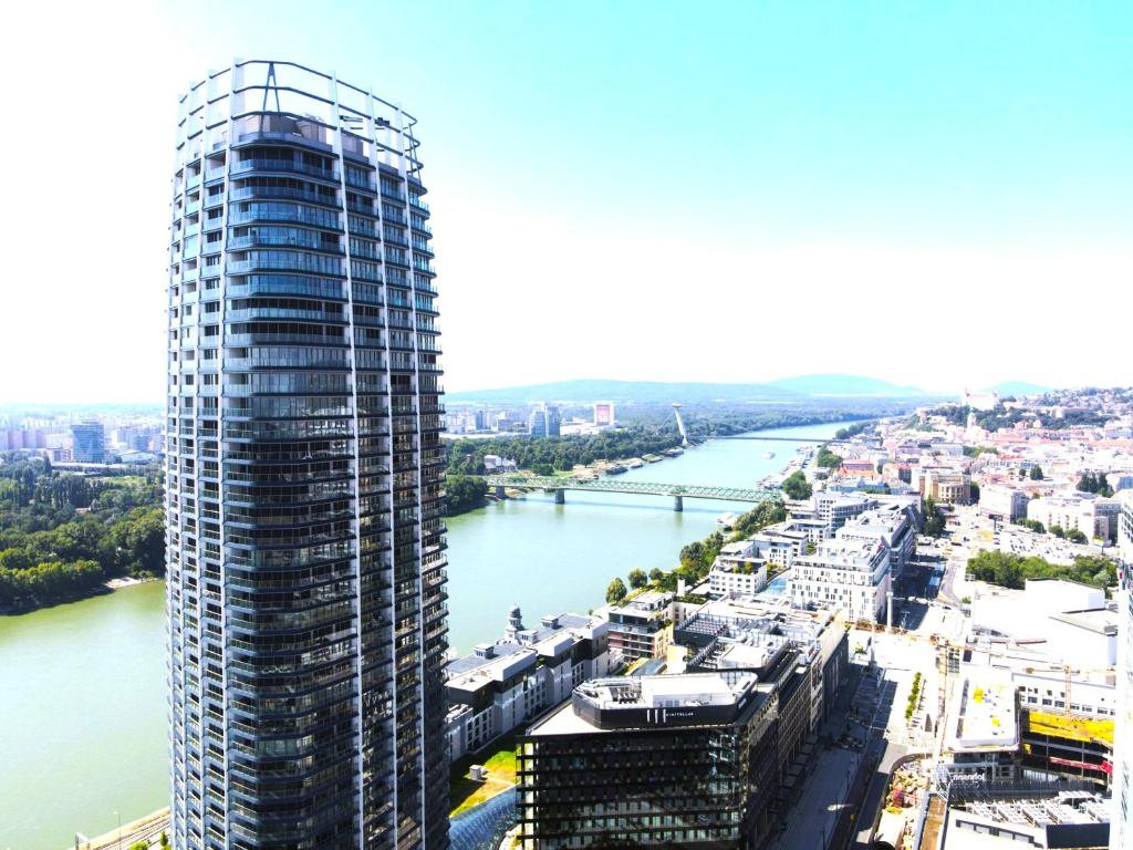 an aerial view of a tall building next to a river at Eurovea Tower Apartment 27th floor, Luxury bed VISPRING Baronet Superb in Ovsište