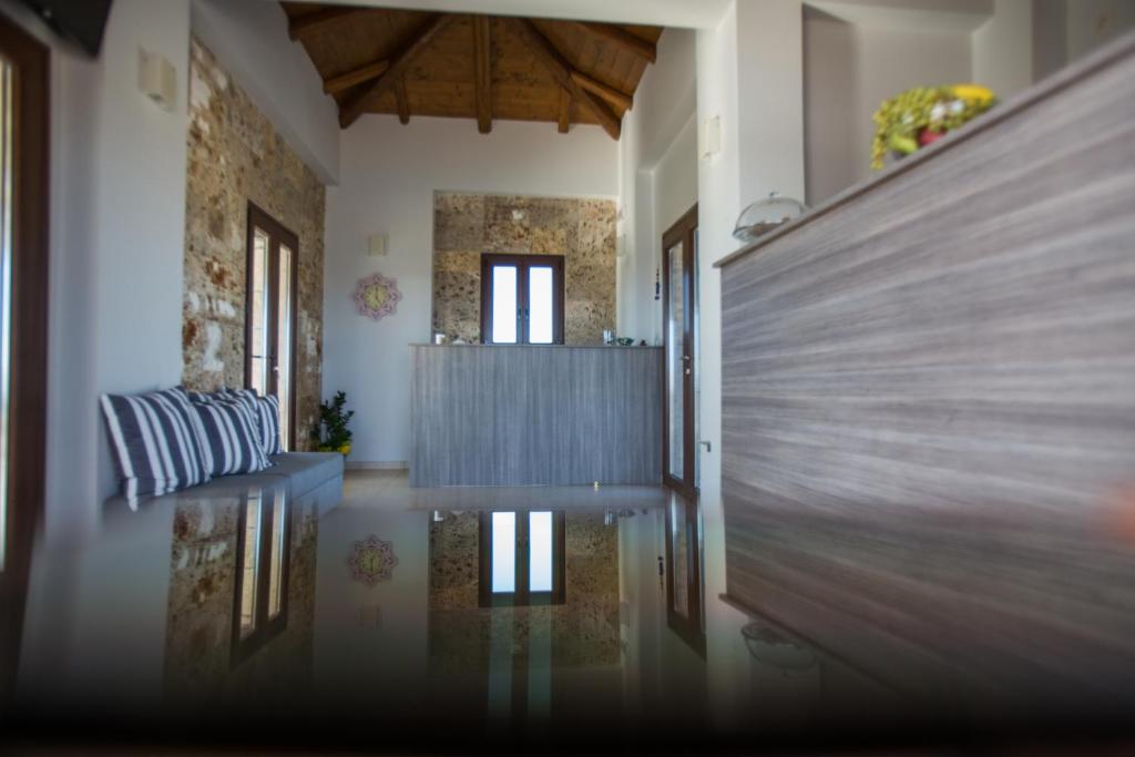 a hallway with a table and a couch in a room at Tramonto Suites in Xi