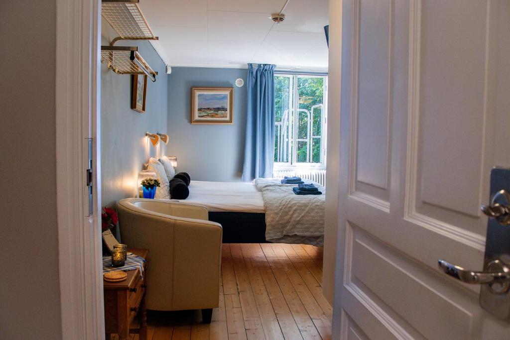 a room with a bedroom with a bed and a window at Villa Storfors in Storfors