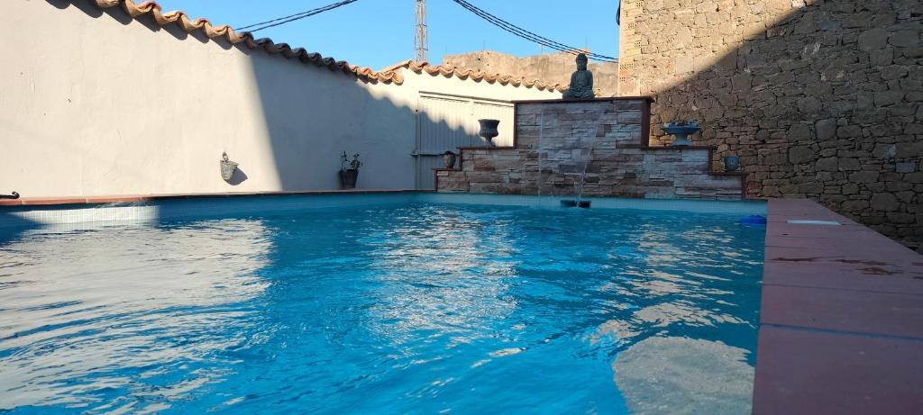 a swimming pool with blue water in a house at Cal Belló in Hostafranco