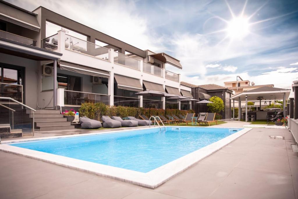 an image of a swimming pool in front of a house at Amalia Center in Nea Vrasna