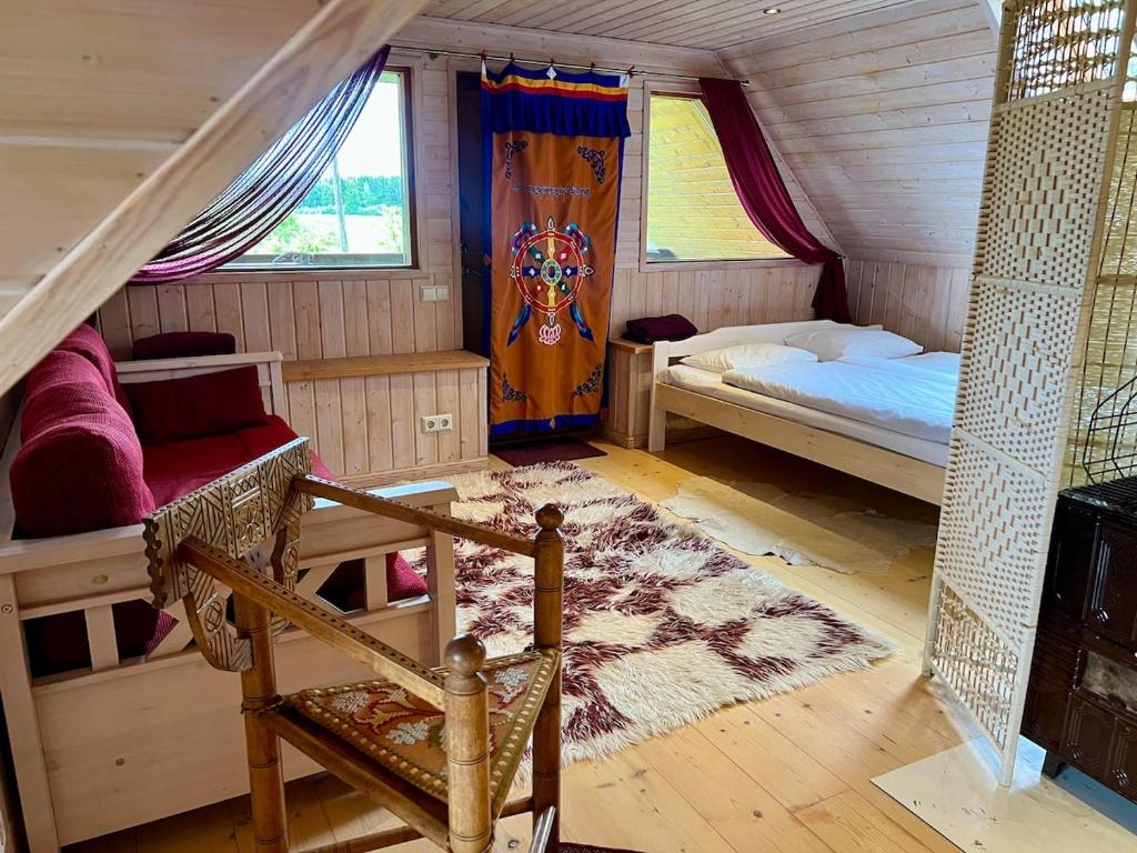a bedroom with a bed and a chair in a room at Countryhome apartment in Jõõpre