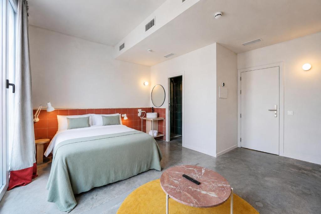 a bedroom with a large bed and a table at Password to Madrid Casa de Campo in Madrid