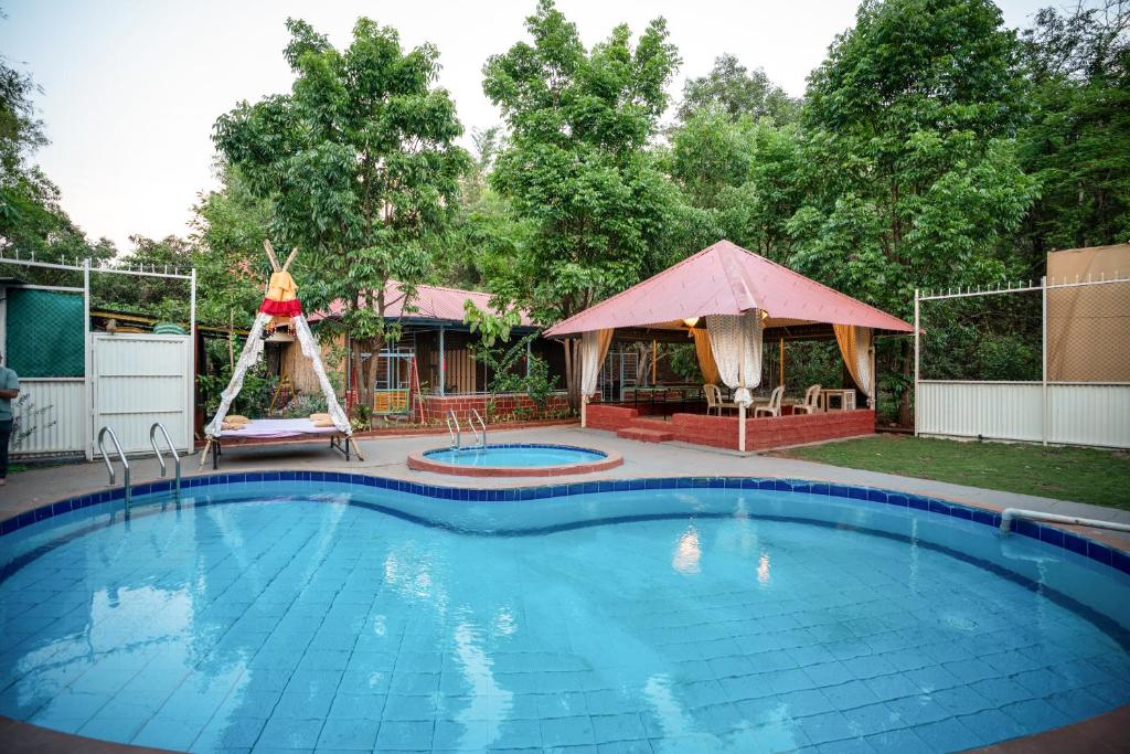 a swimming pool in a yard with a gazebo at Giri Mandala The Mountain Vihar in Welhe