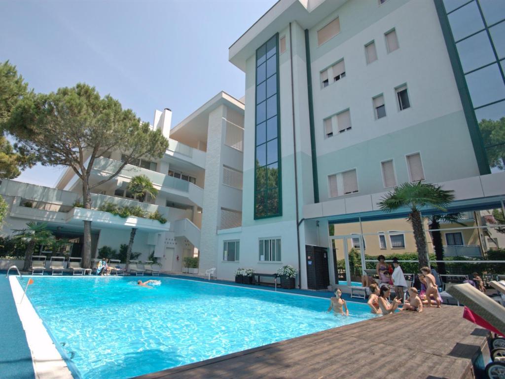 a swimming pool in front of a building at Hotel Sorriso in Milano Marittima