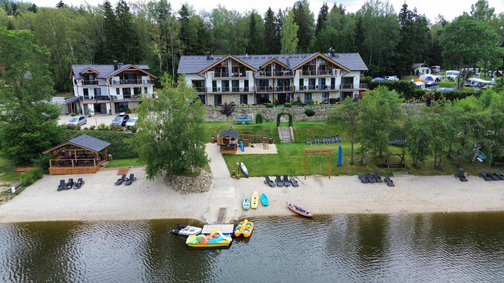 an aerial view of a large house with a beach and water at Rezidence KUPEC in Frymburk