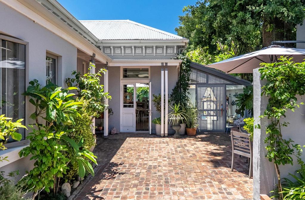 a house with a brick pathway leading to the front door at Himmelblau Boutique Bed and Breakfast in Cape Town