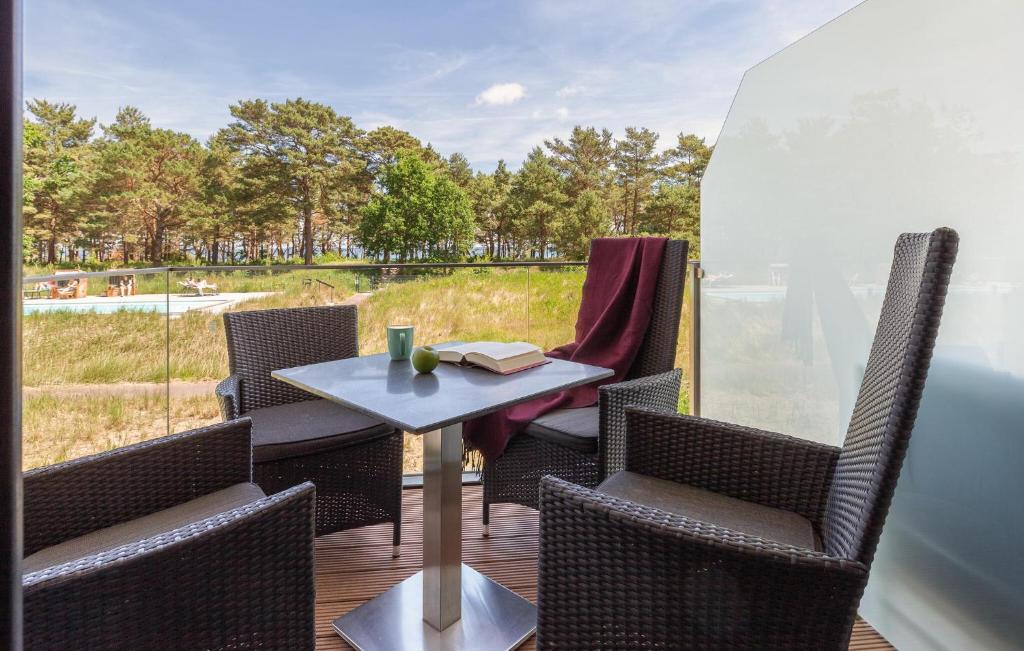 a table and chairs on a deck with a view at Junior in Binz