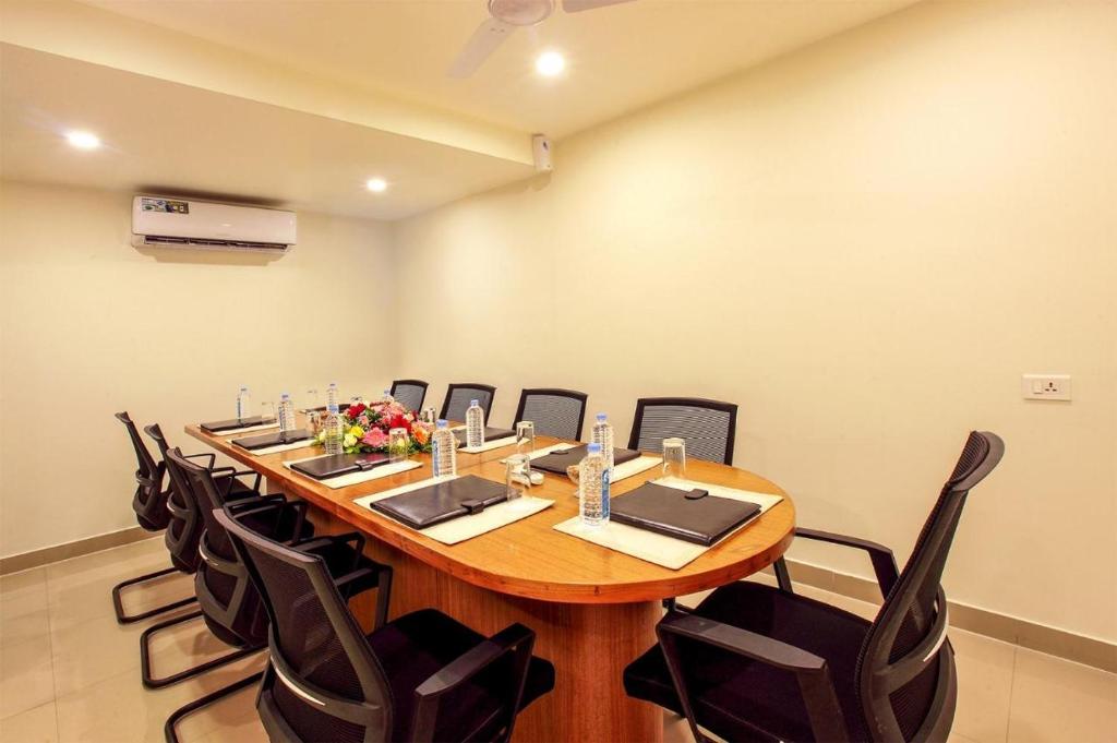a large conference room with a long table and chairs at Chandni Park in Ernakulam