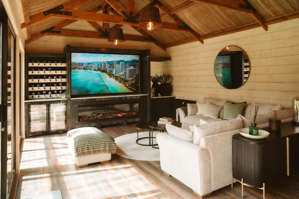 a living room with a couch and a tv at The Forest Loft in Drumsurn