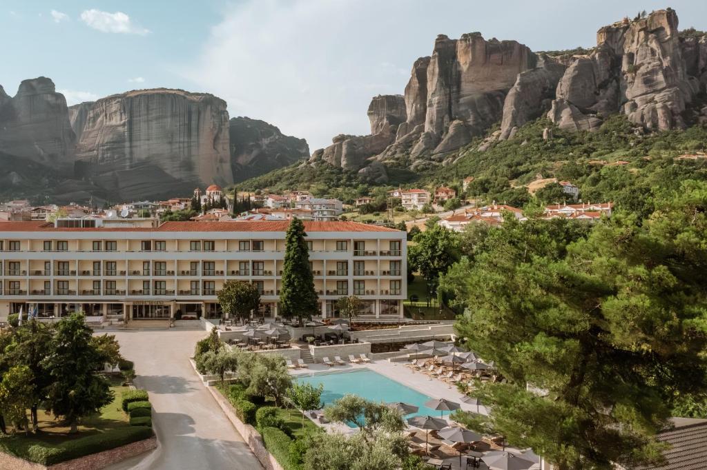 a view of a hotel with mountains in the background at Divani Meteora Hotel in Kalabaka