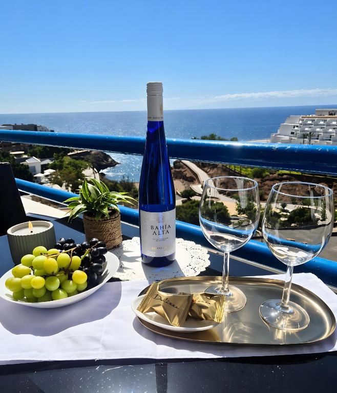 a table with wine glasses and a plate of grapes at Dream Ocean Sunset in Playa Paraiso