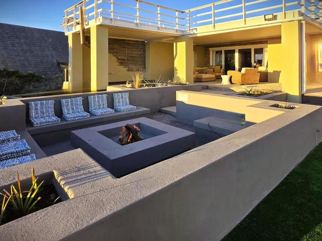 a patio with couches and a fire pit at Eternal @ Yzerfontein in Yzerfontein