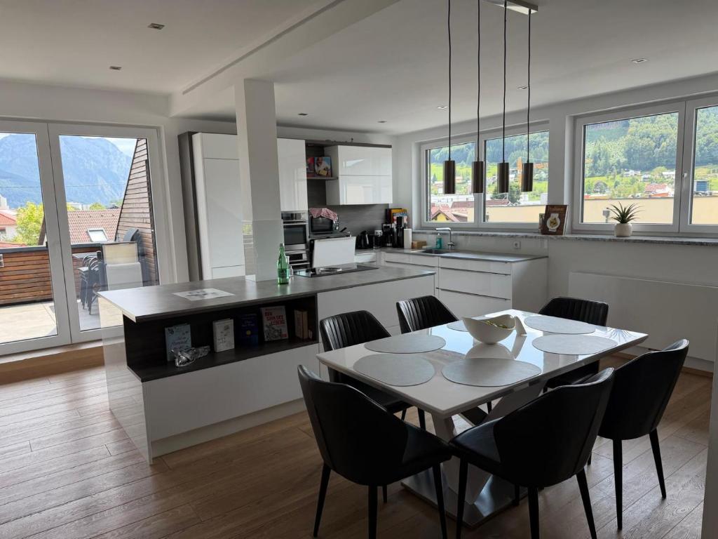 a kitchen with a table and chairs in a room at Ferienwohnung Moser in Pinsdorf