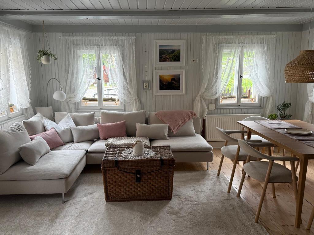 a living room with a white couch and a table at Haus Bergverliebt in Sebnitz