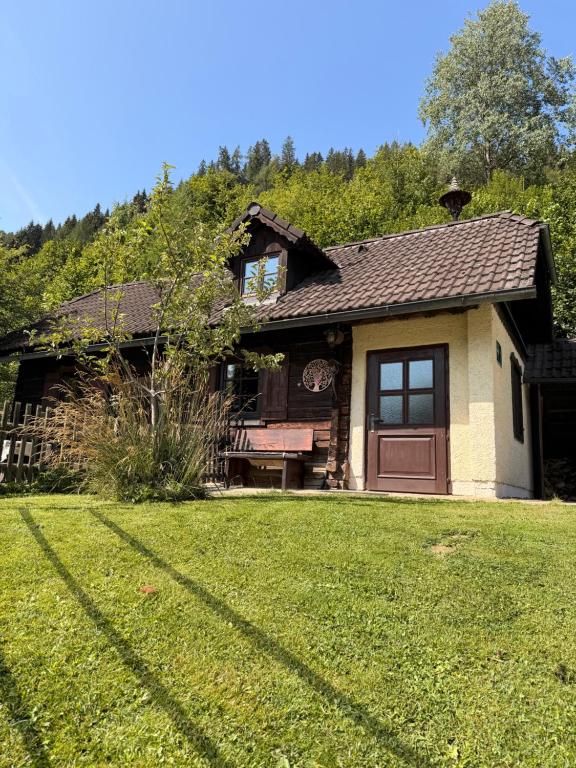 a house with a grass yard in front of it at Umundumhütte in Katsch an der Mur