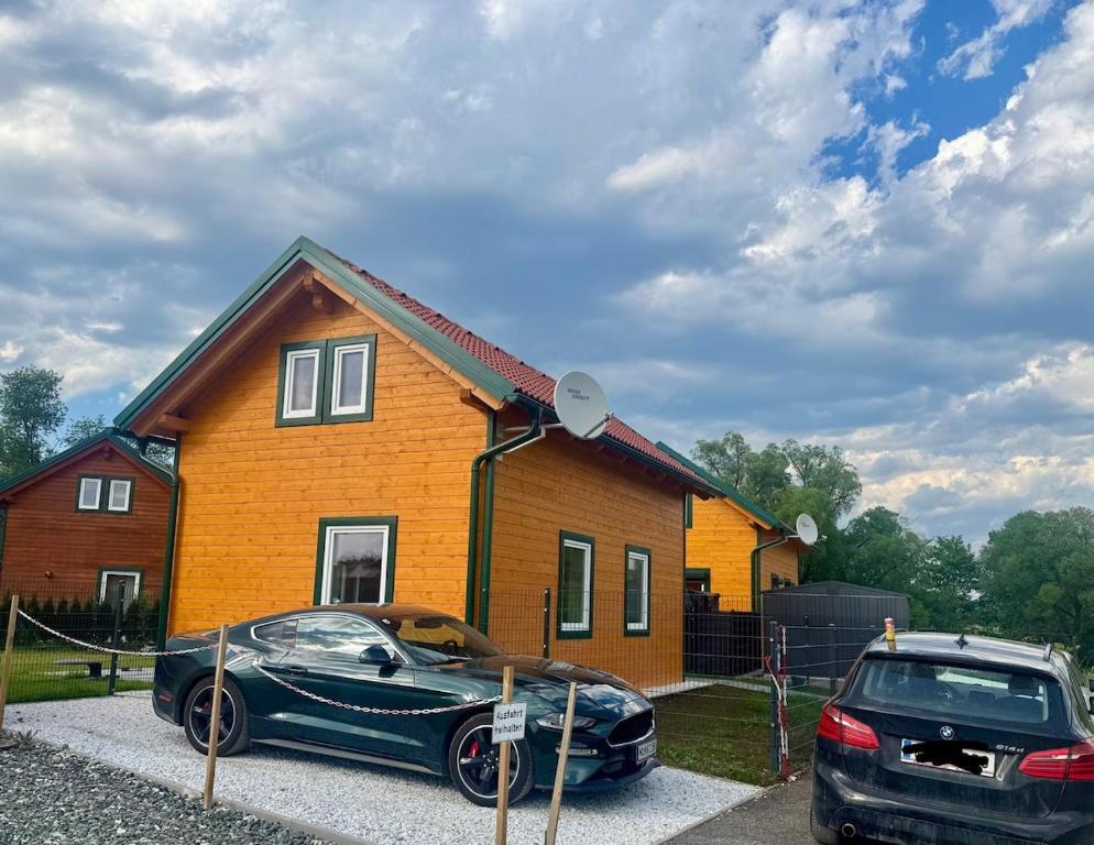 a black car parked in front of a house at Blockhaus Wassermann Spielberg in Spielberg