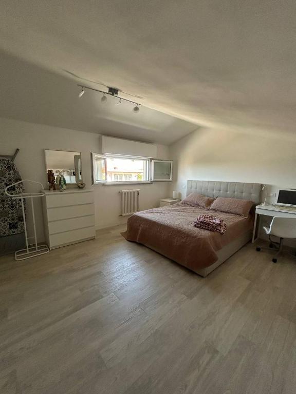a bedroom with a bed and a desk in it at Summer Nest in Cecina