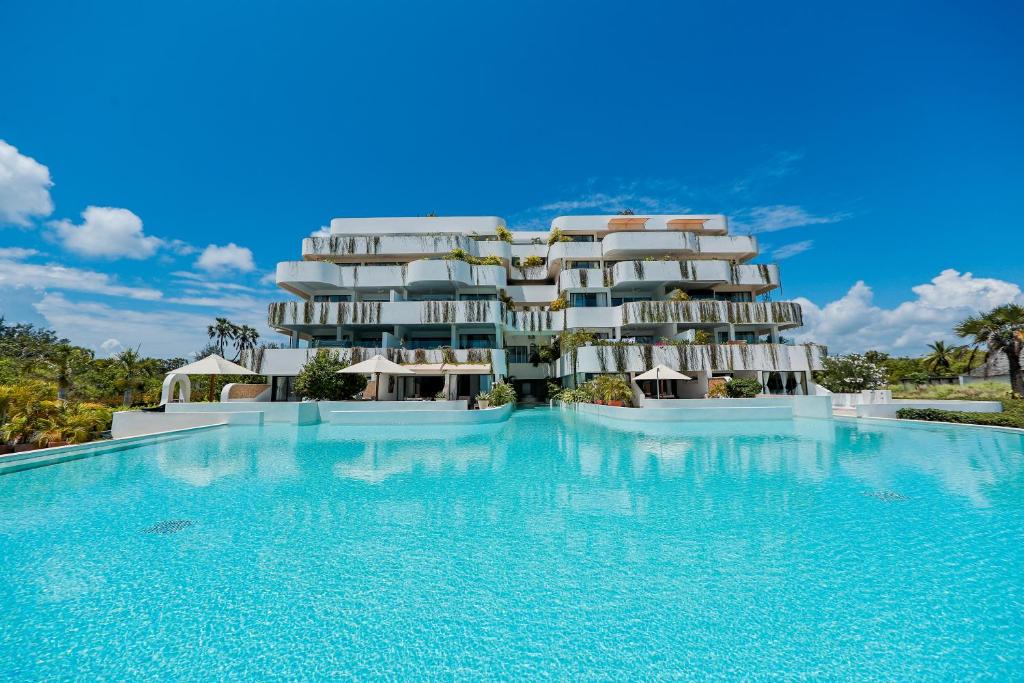 a resort with a large swimming pool in front of it at One Ocean Hotel Apartments by Nest & Nomad in Msambweni