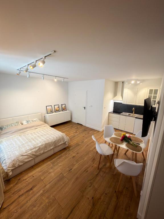 a bedroom with a bed and a table and chairs at Furman's Court in Lublin