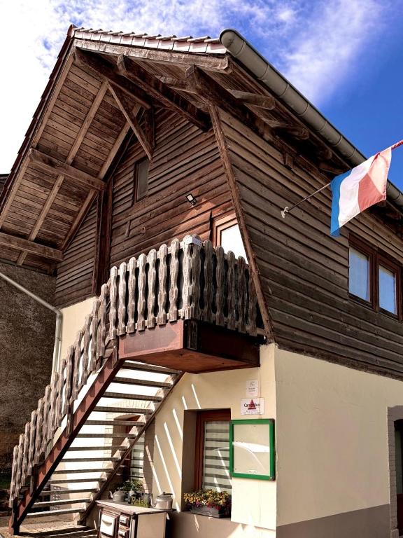 a building with a staircase on the side of it at Cozy Cottage - Authentic apartment in Mullerthal in Waldbillig