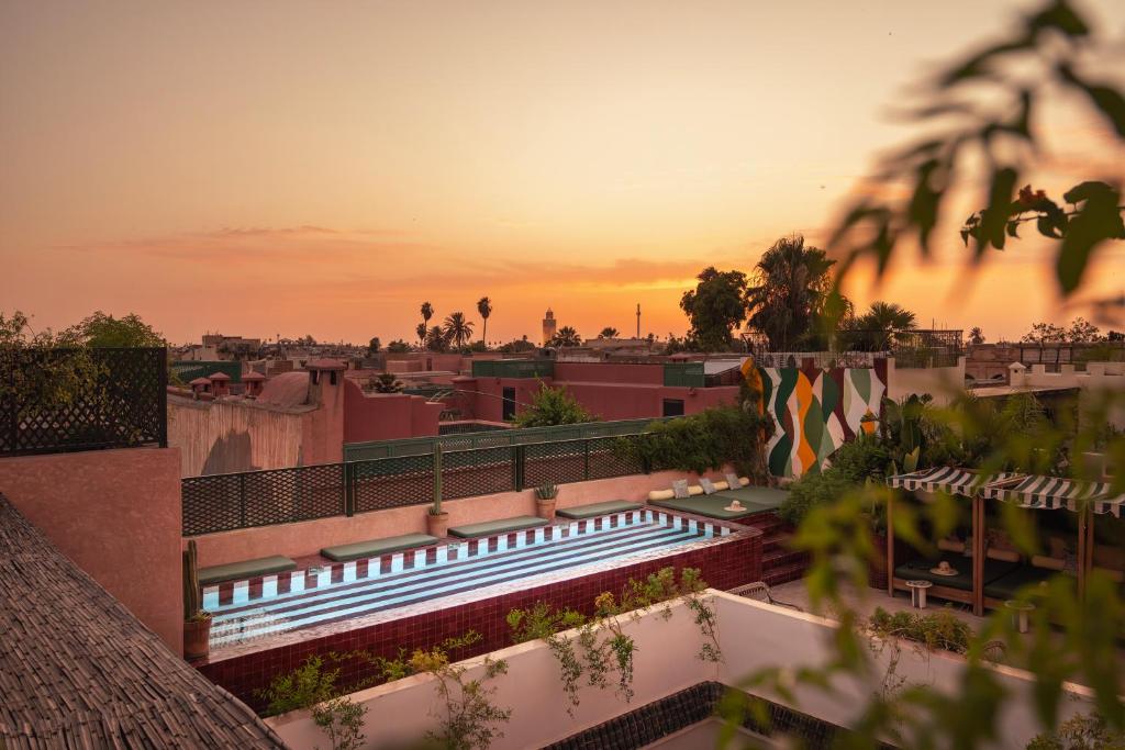 a view of a building with the sunset in the background at The Mellah Hotel in Marrakesh