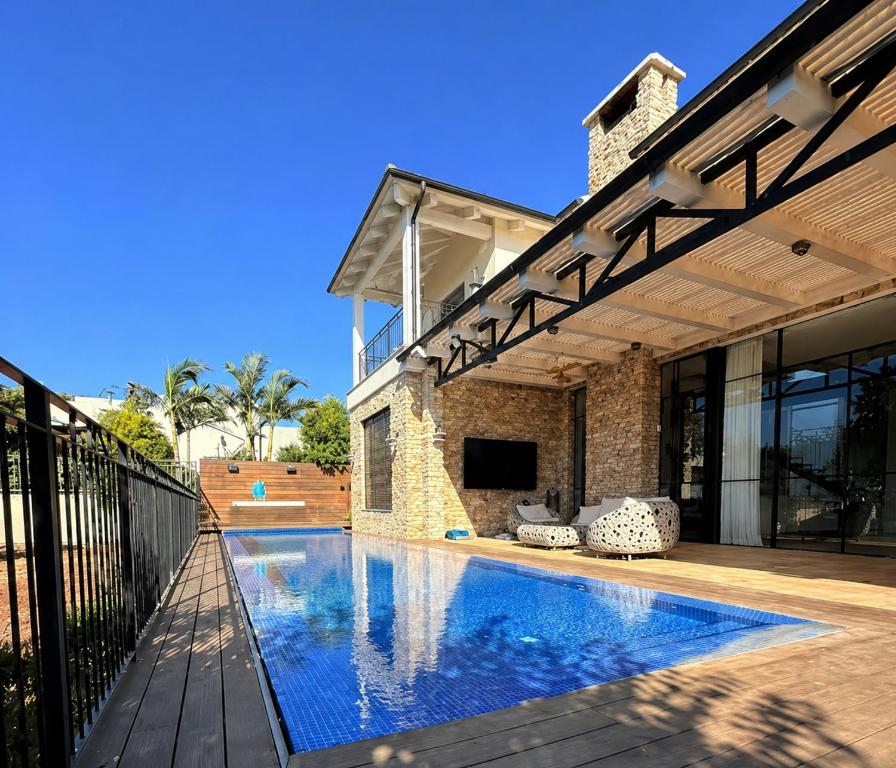 a house with a swimming pool next to a building at Casa del Barone - וילה יוקרתית עם בריכה פרטית in Kefar Tavor