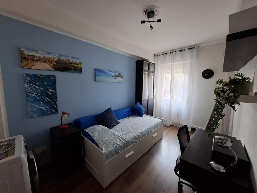 a bedroom with a bed with a blue wall at Home G & D in Monza