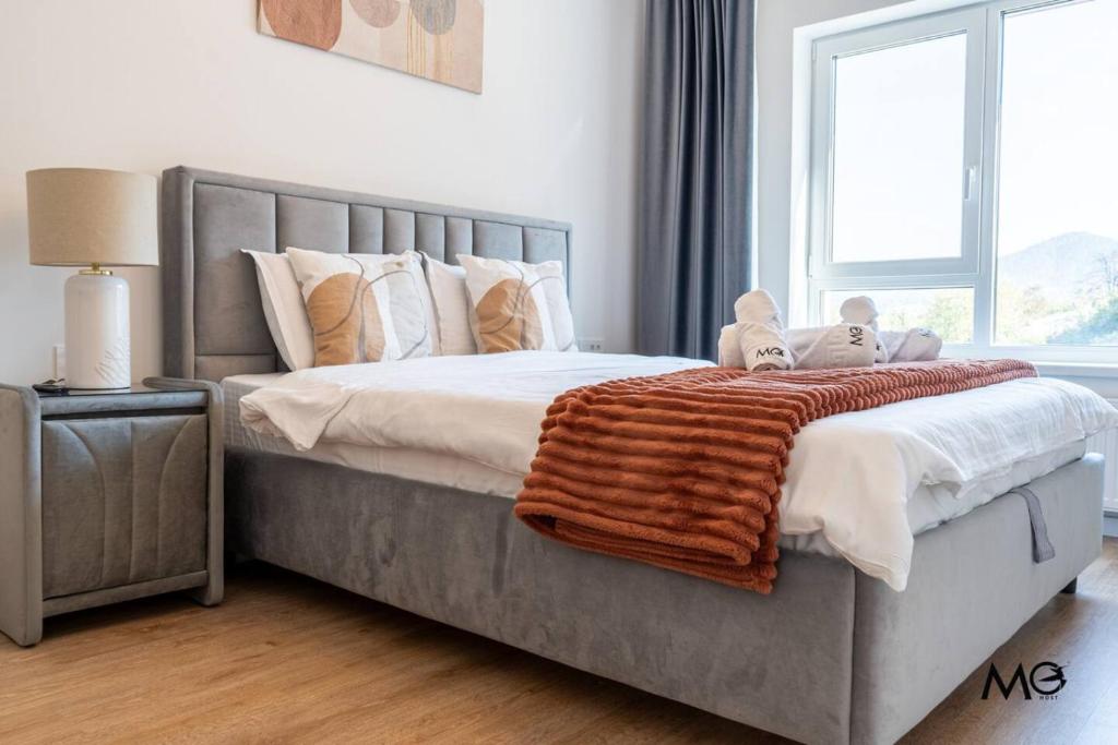 a bedroom with a bed with two stuffed animals on it at Noua Suites in Braşov