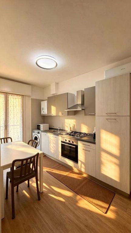 a kitchen with a table and a dining room at Casa Gigi a Sottomarina in Chioggia