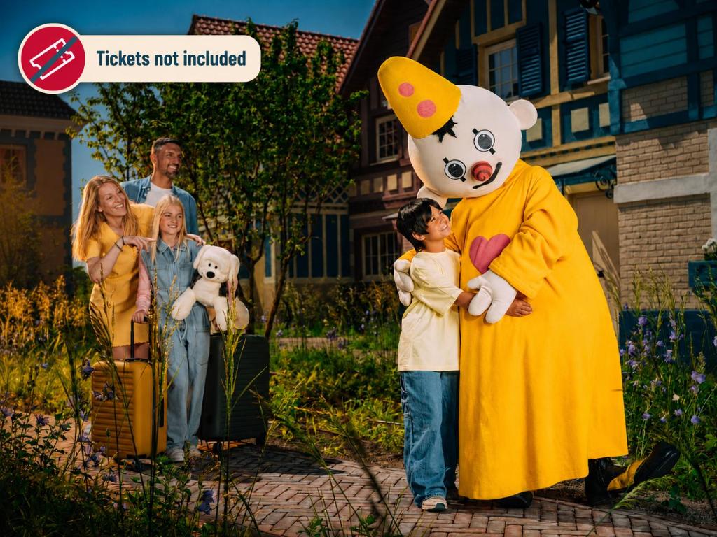 a family dressed up in a large teddy bear costume at Plopsaland Village in De Panne