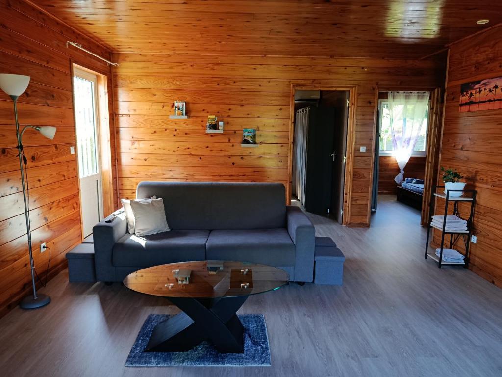 a living room with a couch and a table at Le ptit coin mont vert in Saint-Pierre