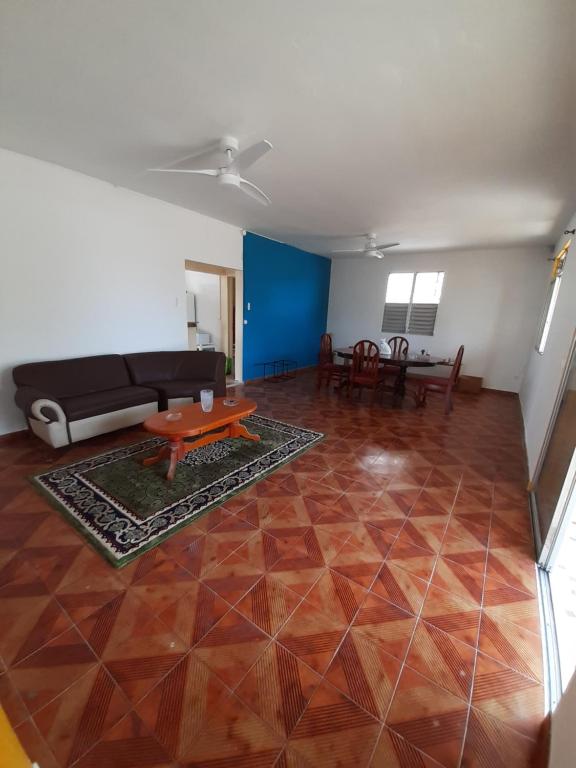 a living room with a couch and a table at Au D LOCATION in Grand-Bourg