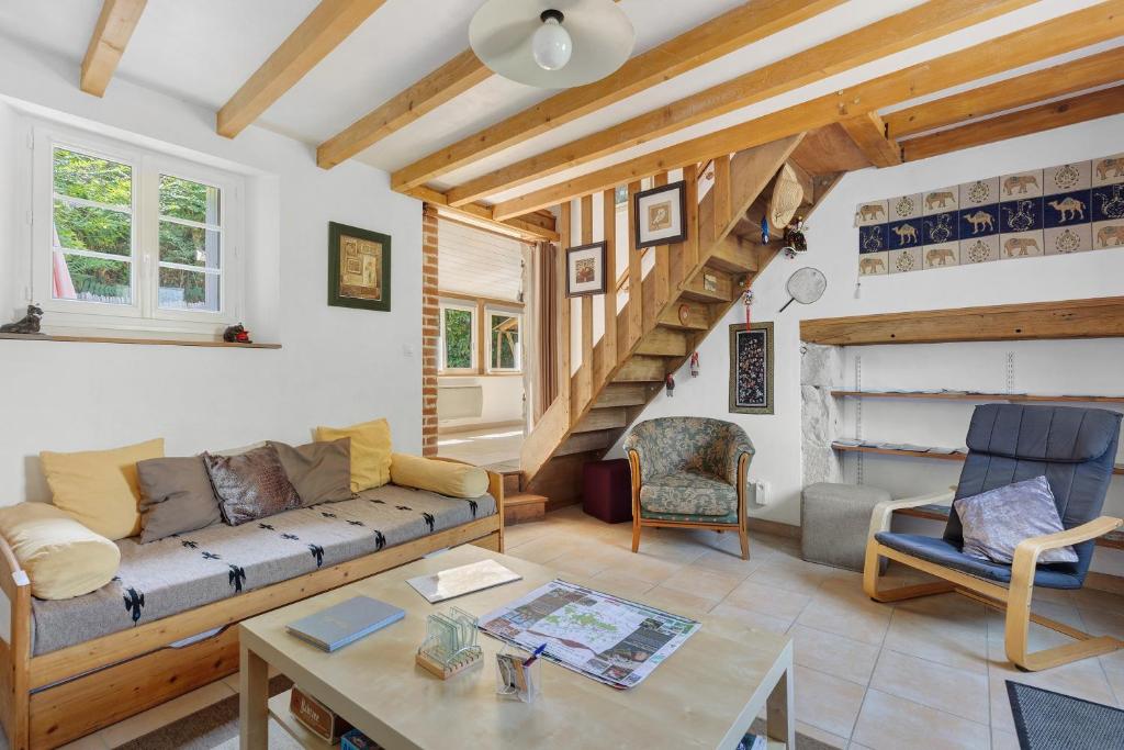 a living room with a couch and a table at Gîte Mélany in Chargé