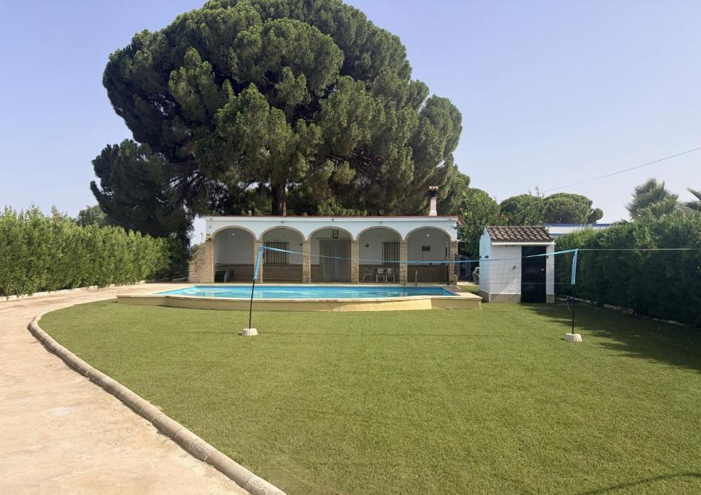 a house with a swimming pool in a yard at Villa Mia in Marchena
