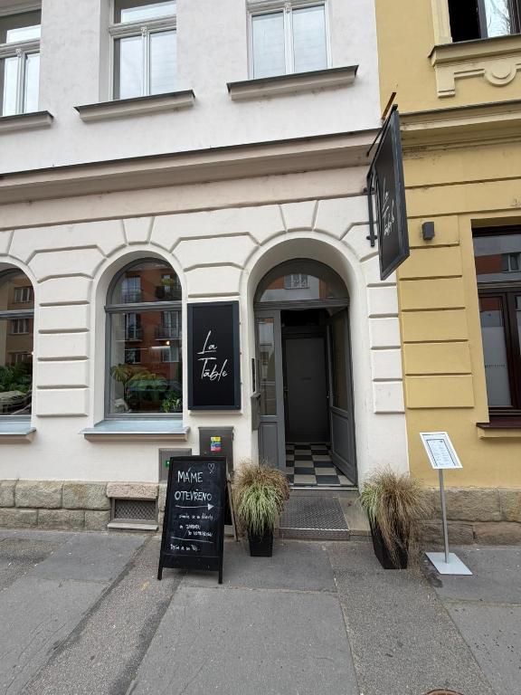 a store with a sign in front of a building at La Brloh Pardubice in Pardubice