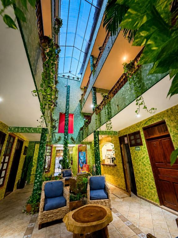 a lobby with two chairs and a table in a building at Kaa Zihil Hotel in Playa del Carmen