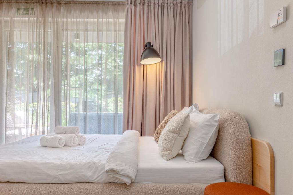 a bedroom with a bed with two towels on it at Sunny Hill in Palanga