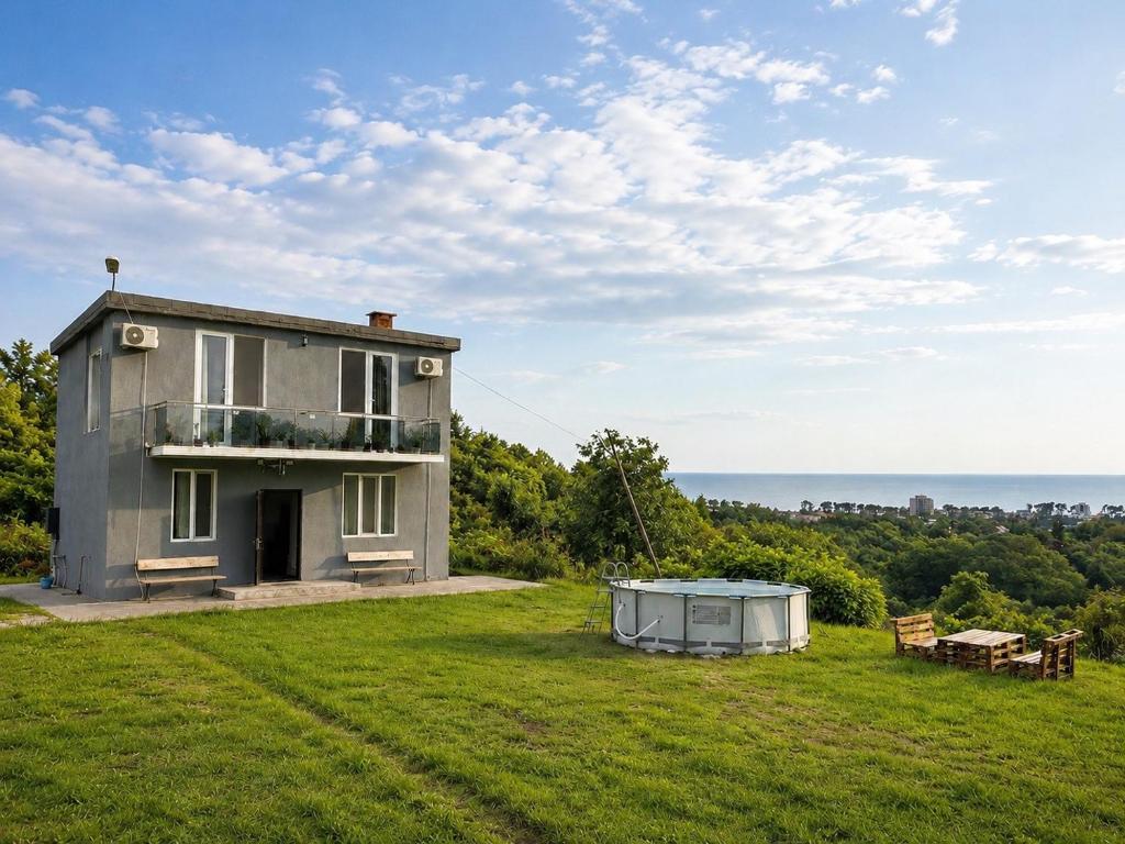 a house on top of a field with a table at Kibula Horizon in Ureki