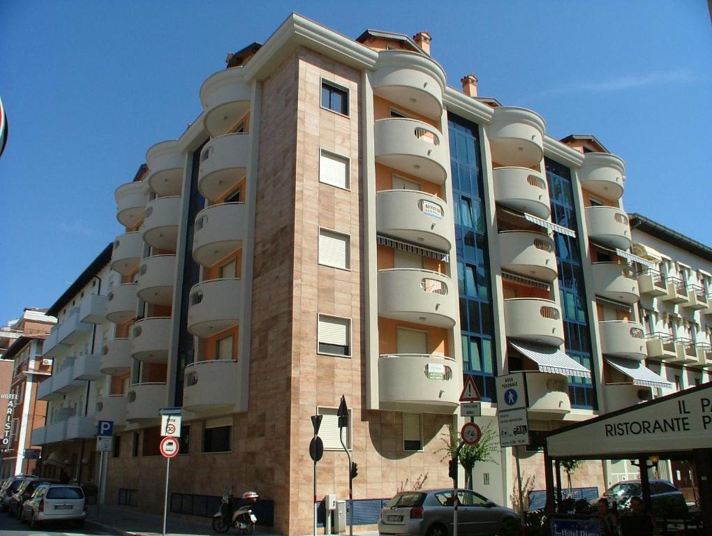 a large apartment building with balconies on a street at Residence Mirage in Grado