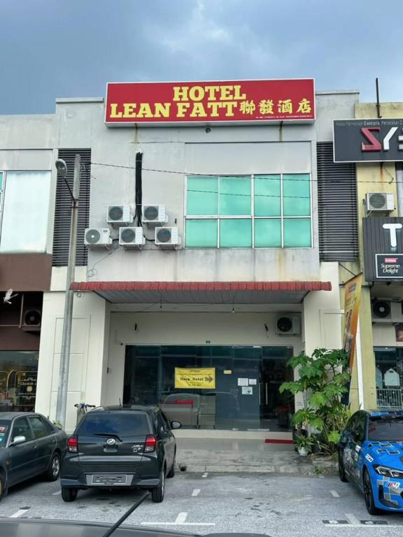 a hotel with cars parked in front of it at Hotel Lean Fatt in Ipoh