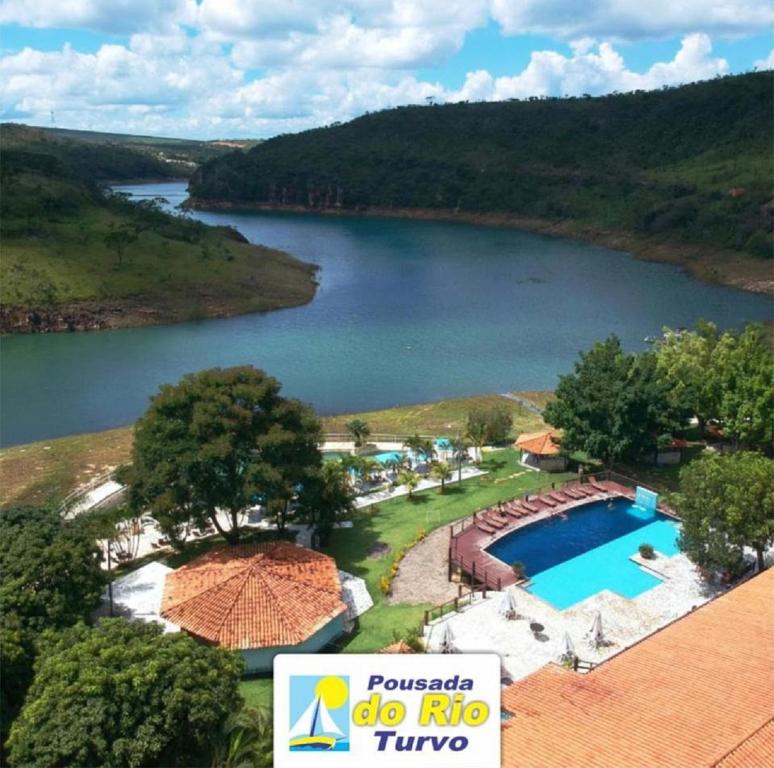 an aerial view of a river and a swimming pool at Pousada do Rio Turvo in Capitólio